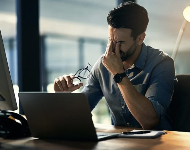 Introspective man sitting alone, reflecting on hidden signs of low masculine confidence